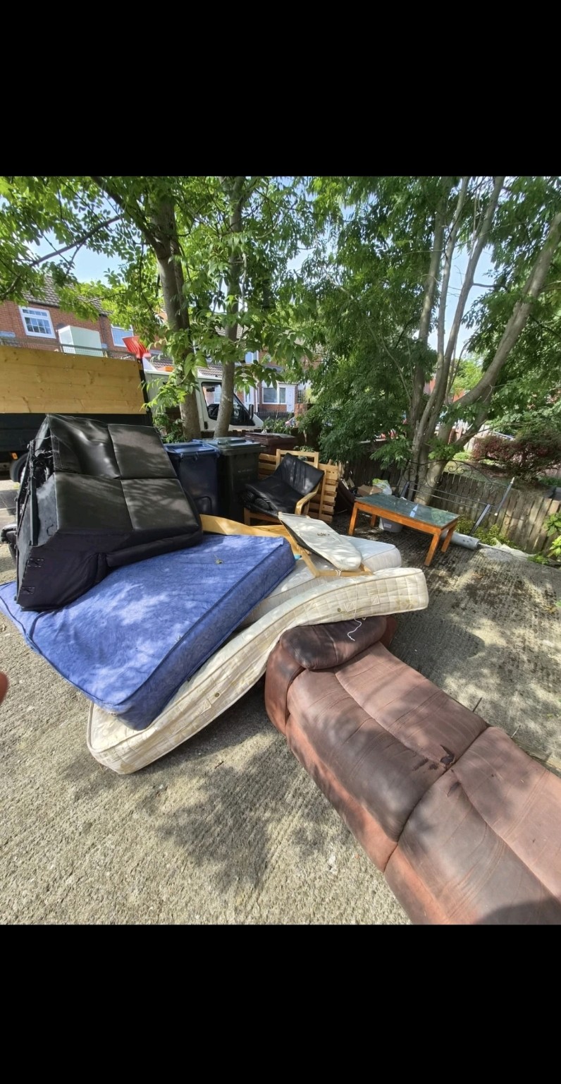Property garden with unwanted furniture before clearance
