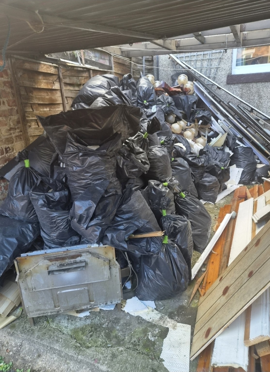 Builders waste in a yard before clearance